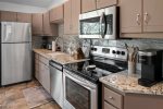 The kitchen is fully equipped with modern appliances and amenities